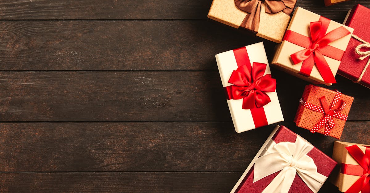 Beautifully wrapped holiday gifts with ribbons on a wooden surface, perfect for Christmas celebrations.